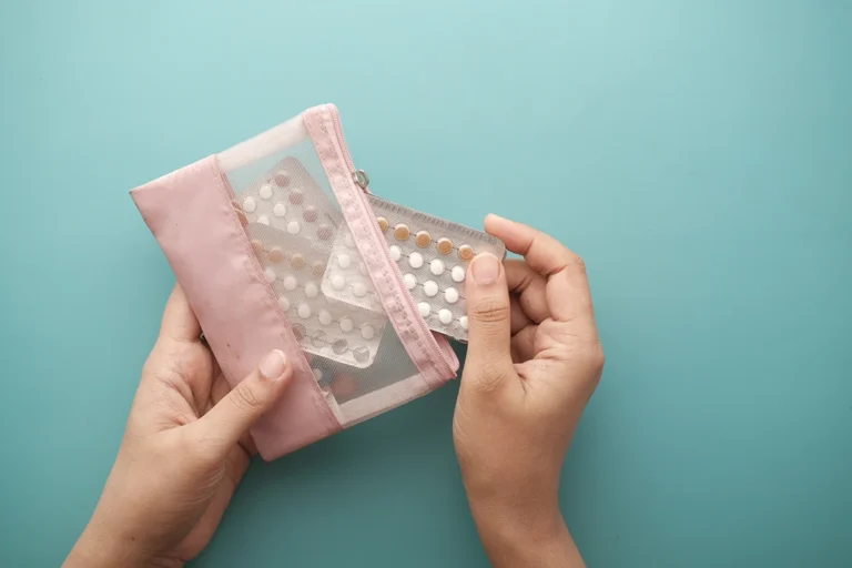 contraception study - women hand holding birth control pills close up