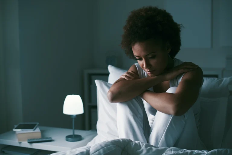 Major Depressive Disorder - Depressed woman sitting in her bed