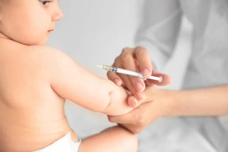 pediatric vaccine - Professional pediatrician vaccinating baby, close up