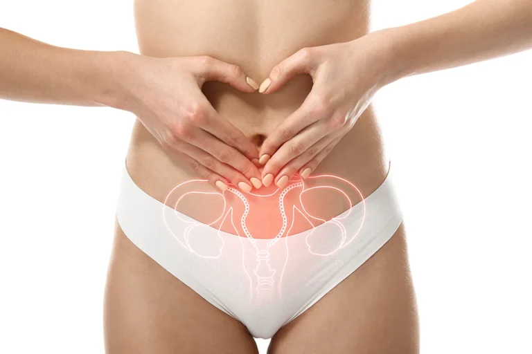 Uterine fibroid study -Young woman with drawing of reproductive system on white background, closeup. Gynecology concept